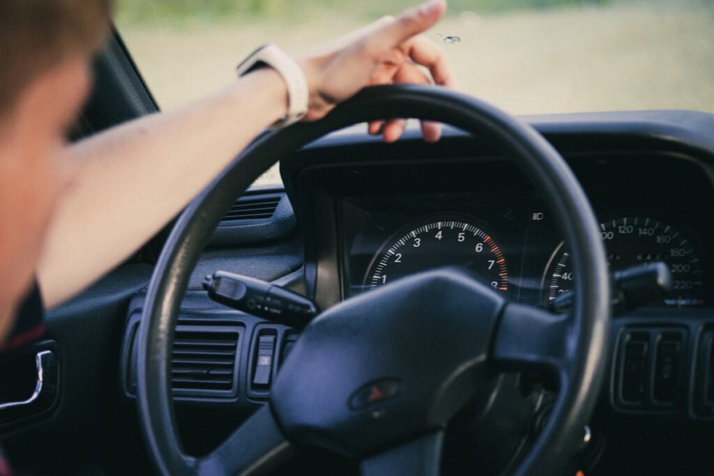 A Hand on a Steering Wheel