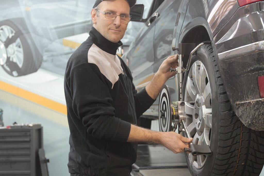 Man in Black Jacket Standing Beside Black Car