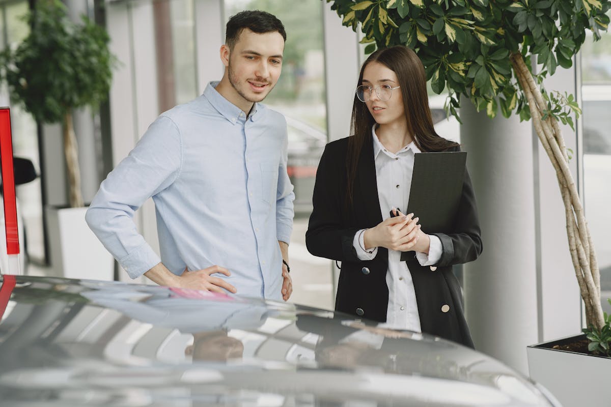 Man and Woman Looking at a Car