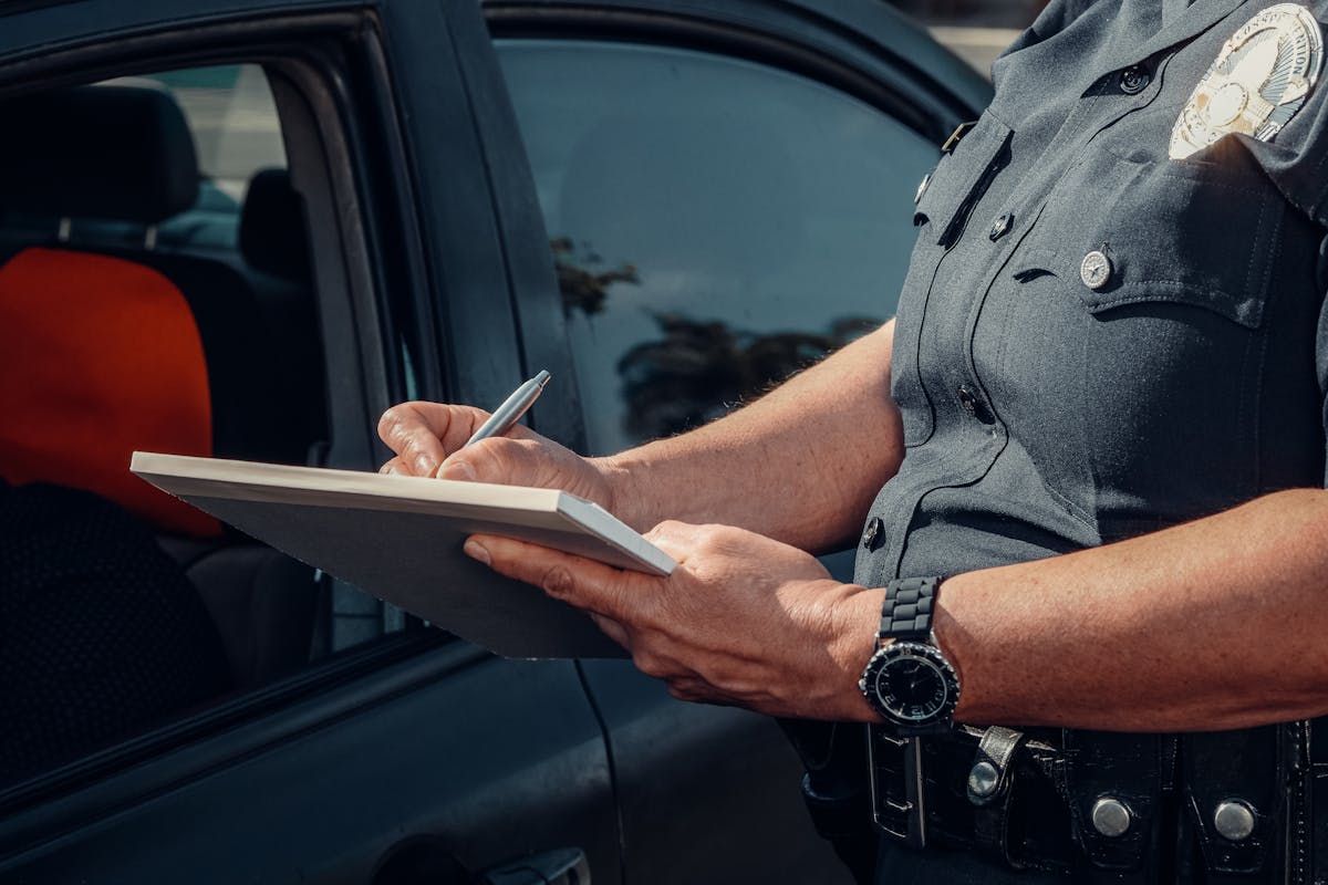 Police Officer Writing on a Notebook