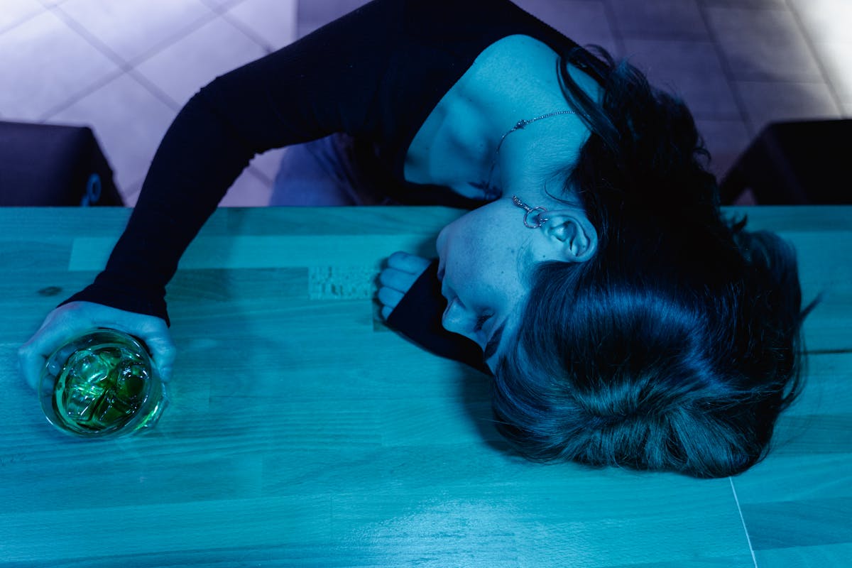 A Woman Passing Out in a Bar Counter