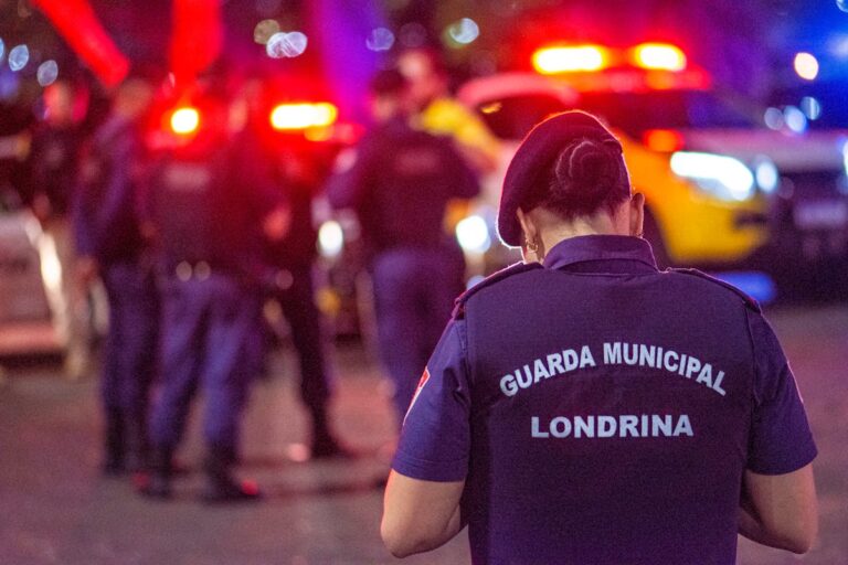 Back View of Municipal Guard on Street in City at Night