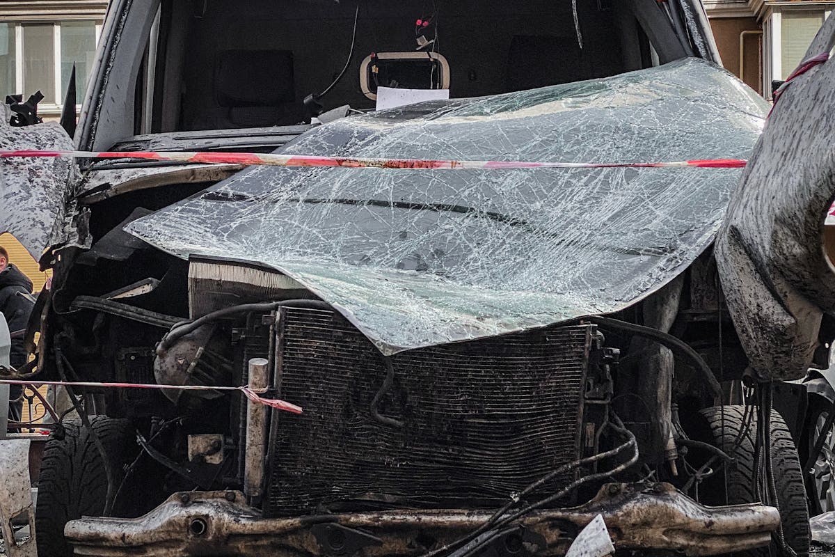 Destroyed Car by Residential Building