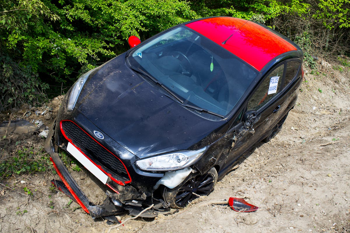 Red and Black Car on Dirt Road